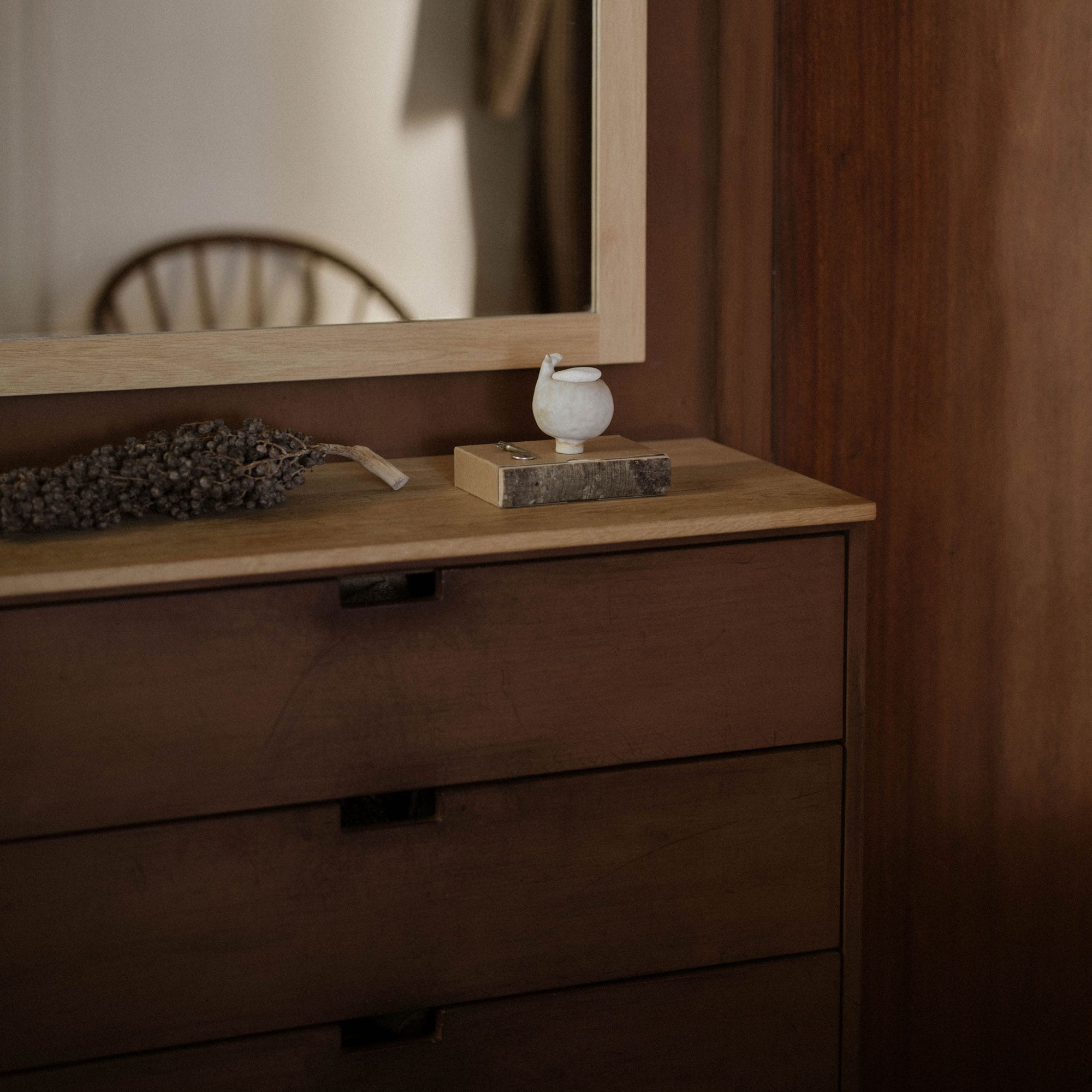 Brown chest of drawers with solid oak top and a mirror above